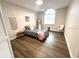 Bedroom with luxury vinyl flooring, closet, large window and neutral paint at 10287 Fordham St, Spring Hill, FL 34608