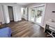 Bedroom with luxury vinyl flooring, closet, desk and doors to patio at 10287 Fordham St, Spring Hill, FL 34608