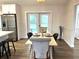 Bright eat-in kitchen with stainless steel appliances, modern light fixture and luxury vinyl flooring at 10287 Fordham St, Spring Hill, FL 34608