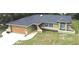 Well-maintained single-story home boasts a modern roof, two-car garage, and mature landscaping at 10287 Fordham St, Spring Hill, FL 34608