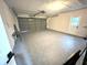 Spacious garage with a large door and room for multiple cars, and included table and storage at 10287 Fordham St, Spring Hill, FL 34608