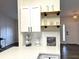 Stylish kitchen featuring white cabinets, quartz countertops, and open shelving, perfect for entertaining at 10287 Fordham St, Spring Hill, FL 34608