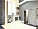 Bright kitchen features white cabinets, floating shelves, quartz countertops and stainless steel appliances at 10287 Fordham St, Spring Hill, FL 34608
