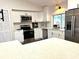 Updated kitchen featuring stainless steel appliances, sleek white cabinets and a bright, inviting atmosphere at 10287 Fordham St, Spring Hill, FL 34608
