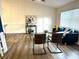 Bright living room featuring wainscoting wall trim, contemporary furnishings, and hardwood flooring at 10287 Fordham St, Spring Hill, FL 34608
