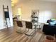 Light filled living room with wainscoting wall trim, hardwood floors, and modern decor at 10287 Fordham St, Spring Hill, FL 34608