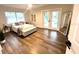Spacious main bedroom with french doors leading to pool area and luxury vinyl flooring at 10287 Fordham St, Spring Hill, FL 34608