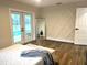 Bright main bedroom featuring luxury vinyl flooring, french doors and custom mill work at 10287 Fordham St, Spring Hill, FL 34608