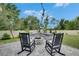 Backyard featuring a custom stone fire pit with built in seating at 10399 Boyette Brook St, Riverview, FL 33569
