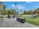 Spacious backyard featuring a playset, fire pit, and ample space for outdoor activities at 10399 Boyette Brook St, Riverview, FL 33569