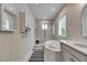 Bright bathroom featuring a soaking tub and separate glass shower with a white vanity at 10399 Boyette Brook St, Riverview, FL 33569