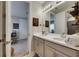 Bathroom with a double vanity and a shared mirror with modern lighting fixtures and light colored walls at 10399 Boyette Brook St, Riverview, FL 33569