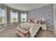 Bright bedroom with a large bed and a window seat providing lots of natural light at 10399 Boyette Brook St, Riverview, FL 33569