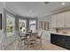 Charming breakfast nook features a round table, a bay window, and a view into the backyard at 10399 Boyette Brook St, Riverview, FL 33569