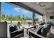 Relaxing covered patio with cozy seating and a view of the backyard's playset at 10399 Boyette Brook St, Riverview, FL 33569