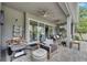 Charming covered patio boasts comfortable seating, an outdoor kitchen, and access to the backyard at 10399 Boyette Brook St, Riverview, FL 33569