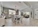 Well-lit dining room showcases hardwood floors, wainscotting, and views to the living room at 10399 Boyette Brook St, Riverview, FL 33569
