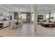 Elegant dining room open to the living area, featuring a chandelier and ample natural light at 10399 Boyette Brook St, Riverview, FL 33569