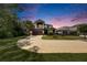 Two-story home at dusk featuring a basketball hoop, two-car garage, and landscaped lawn at 10399 Boyette Brook St, Riverview, FL 33569