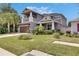 Two-story home featuring a two-car garage, manicured lawn and lush landscaping at 10399 Boyette Brook St, Riverview, FL 33569
