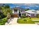 Charming two-story home features a well-manicured lawn, inviting front porch, and attached two-car garage at 10399 Boyette Brook St, Riverview, FL 33569