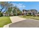 Charming two-story home features a well-manicured lawn, inviting front porch, and attached two-car garage at 10399 Boyette Brook St, Riverview, FL 33569