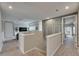 View of the upstairs hallway with gray walls and white trim leading to a living area with a TV at 10399 Boyette Brook St, Riverview, FL 33569