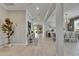 Inviting hallway showcasing wood-look tile flooring, leading to various rooms within the home at 10399 Boyette Brook St, Riverview, FL 33569