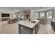 Bright kitchen with large island, stainless steel sink, and an adjacent breakfast nook overlooking the backyard at 10399 Boyette Brook St, Riverview, FL 33569