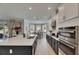 Well-lit kitchen with white countertops, stainless steel appliances, and a view of the breakfast nook and outdoor area at 10399 Boyette Brook St, Riverview, FL 33569