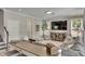 Comfortable living room featuring a mounted TV, hardwood floors, and open space for entertaining at 10399 Boyette Brook St, Riverview, FL 33569