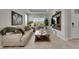 Bright living room featuring neutral tones, recessed lighting, and a tray ceiling, creating a comfortable space at 10399 Boyette Brook St, Riverview, FL 33569