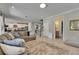 Spacious living room features a gray sectional sofa with a view of the staircase and a glimpse into the bathroom at 10399 Boyette Brook St, Riverview, FL 33569