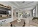 Open concept living room featuring coffered ceilings, decorative columns, and light, airy finishes at 10399 Boyette Brook St, Riverview, FL 33569