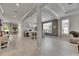 Open-concept living space with wood-look tile flooring, perfect for entertaining and Gathering gatherings at 10399 Boyette Brook St, Riverview, FL 33569