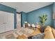 Home office with blue walls and natural light, complemented by a comfortable sofa at 10399 Boyette Brook St, Riverview, FL 33569