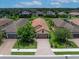 A beautiful aerial shot of a single-Gathering home on a well-manicured lot at 10450 Highland Park Pl, Palmetto, FL 34221