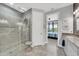 Contemporary bathroom with a frameless shower, modern fixtures, and access to the bedroom at 10450 Highland Park Pl, Palmetto, FL 34221