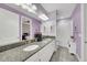 Well-lit bathroom with double sinks, granite countertop, and a shower/tub combo at 10450 Highland Park Pl, Palmetto, FL 34221