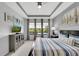 Bright bedroom with a cozy bed, natural light, and stylish decor creating a relaxing atmosphere at 10450 Highland Park Pl, Palmetto, FL 34221