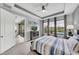 Bedroom with exterior access, tray ceiling, and neutral decor with nature views at 10450 Highland Park Pl, Palmetto, FL 34221
