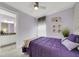 Bedroom with calming lilac walls, neutral carpet, stylish decor and an ensuite bathroom at 10450 Highland Park Pl, Palmetto, FL 34221
