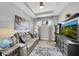 Bonus room with tray ceiling, recessed lights, and a cozy couch at 10450 Highland Park Pl, Palmetto, FL 34221
