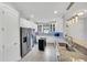 Bright kitchen features stainless steel appliances, white cabinets, and granite countertops at 10450 Highland Park Pl, Palmetto, FL 34221