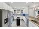 Bright kitchen features stainless steel appliances, white cabinets, and granite countertops at 10450 Highland Park Pl, Palmetto, FL 34221