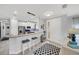 Open-concept kitchen with stainless appliances, white cabinetry, pendant lighting and seating at the breakfast bar at 10450 Highland Park Pl, Palmetto, FL 34221