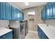 Laundry room with ample cabinet storage and modern appliances at 10450 Highland Park Pl, Palmetto, FL 34221
