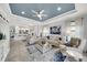 Spacious living room featuring an open layout with views into the kitchen and access to the outdoor patio at 10450 Highland Park Pl, Palmetto, FL 34221