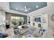 Bright living room showcasing a large entertainment center, blue accent wall, and access to the outdoor patio at 10450 Highland Park Pl, Palmetto, FL 34221