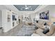 Open-concept living room showing the layout to the kitchen and access to the outdoor patio at 10450 Highland Park Pl, Palmetto, FL 34221